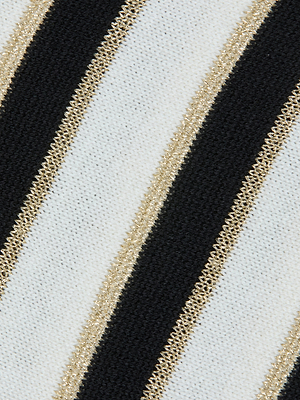 Close-up of the Bishop Striped Sweater, showcasing diagonal black and white stripes bordered by metallic gold accents. The woven fabric texture is clearly visible.