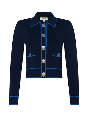 The Tala Cardigan is a navy long-sleeve piece made from luxe blue stretch knit, featuring bright blue trim, four front pockets, and five silver decorative buttons down the center.