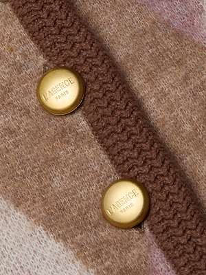 Close-up of two gold buttons engraved with LAGENCE PARIS on the brown knit trim of the Siobhan Cardigan, a beige and brown patterned wool-blend piece.