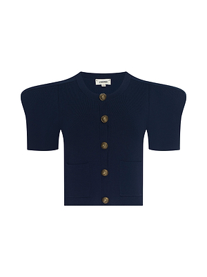 The Britt Statement Shoulder Cardigan is a structured, short-sleeve navy blue piece with gold buttons, two front pockets, and bold shoulder pads, crafted from power stretch knit and shown on a white background.
