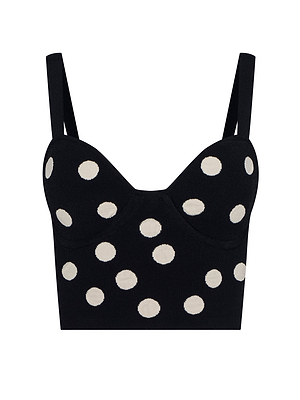 The Tula Knit Bra Top is a black cropped tank with thick straps and bold white polka dots, inspired by the cinematic drama of the Spring 2026 NYFW After Hours collection.