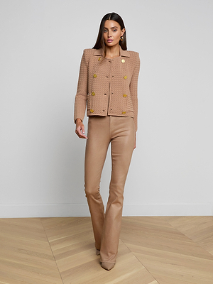 A woman in the Charlie Knit Jacket, a tailored brown piece with gold buttons, paired with matching pants.