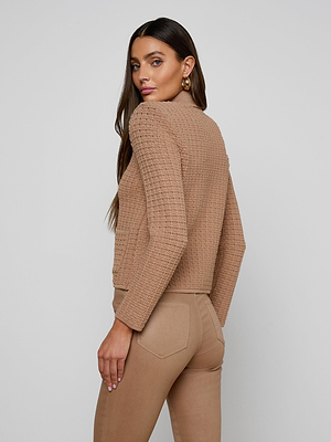 A woman wearing the Charlie Knit Jacket, a brown knit style with gold buttons.