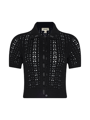 The Ninette Knit Top is a black short-sleeve cardigan featuring a collared neckline, button-down front, and an all-over eyelet pointelle knit pattern.