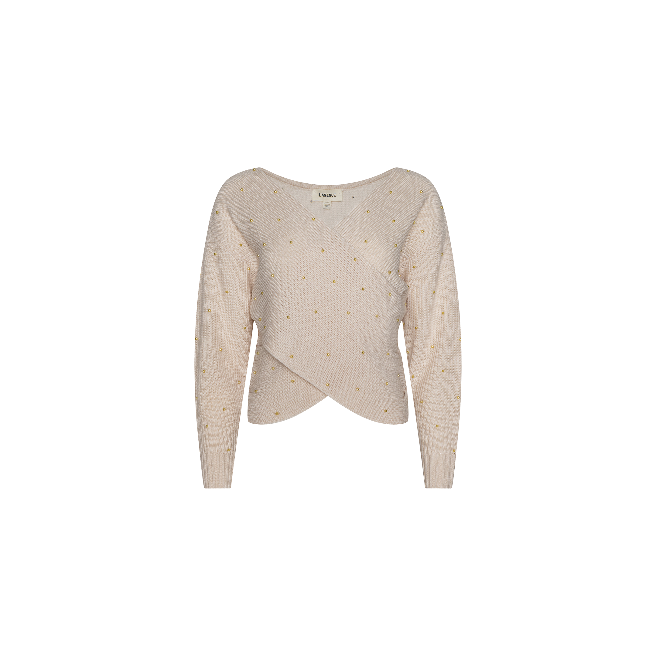 The Antonella Crossover Sweater is a light pink knit with long sleeves, a fitted waist, subtle ribbed texture, and small yellow polka dot pattern, displayed on a plain white background.