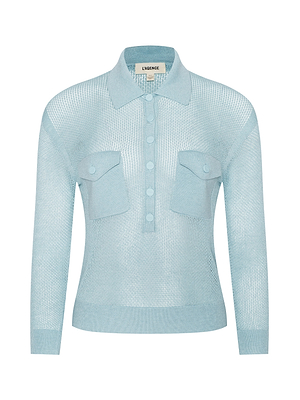The Carine Sweater is a light blue, long-sleeve top in a semi-sheer, lightweight knit with a collar, button placket, and two chest pockets with buttoned flaps. The label inside the collar reads L’AGENCE.
