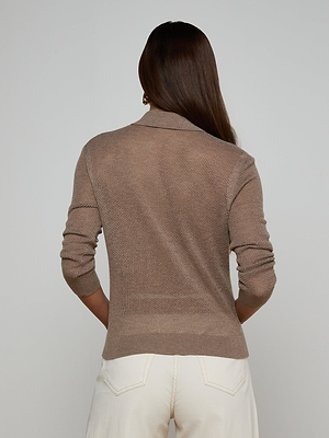 A woman in the Carine Sweater, a brown lightweight knit that’s perfect as an everyday essential.