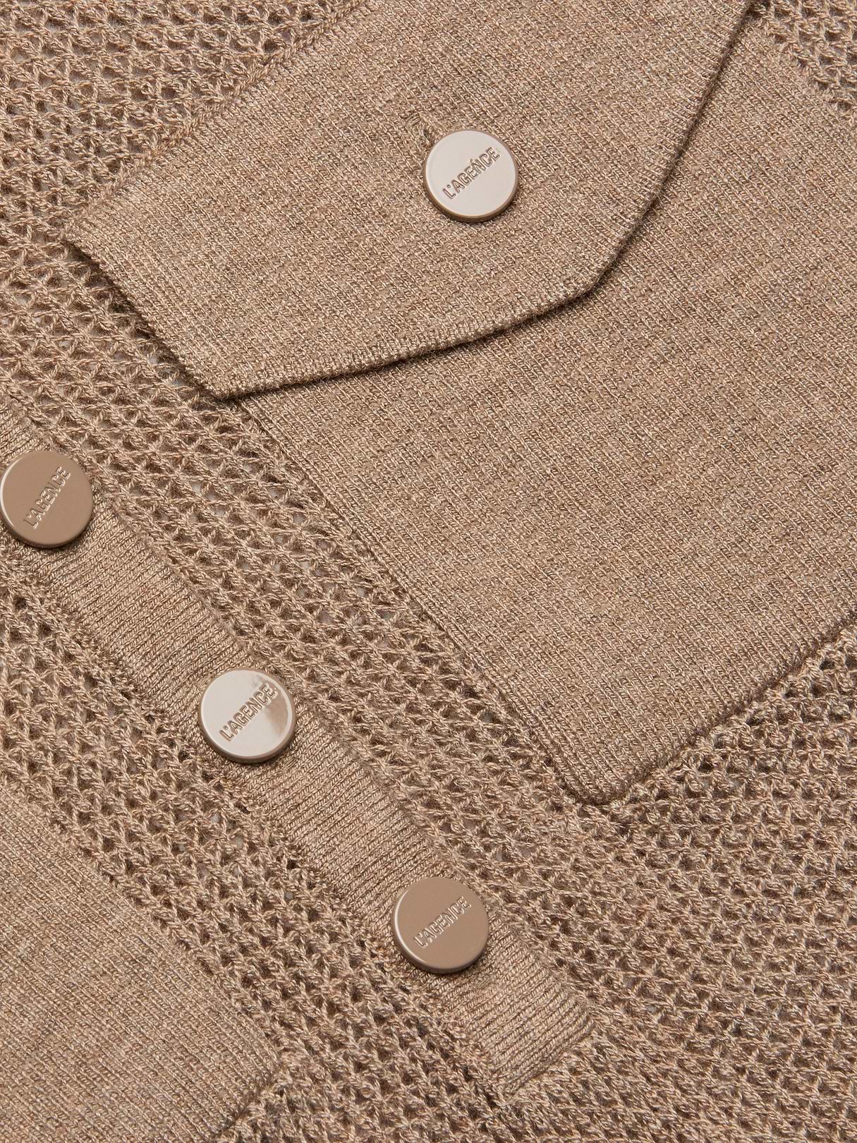 Close-up of the Carine Top in beige lightweight knit fabric with mesh and solid patterns, featuring metallic buttons embossed with LABISSE and a utility pocket flap.