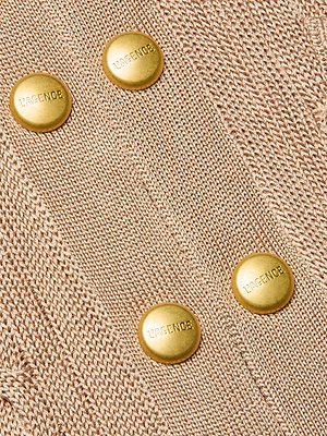 Close-up of the Penelope Cabled Cardigan in camel, featuring four diagonally arranged gold LAGENCE-embossed buttons. The cable knit texture and shiny logo buttons are clearly showcased.