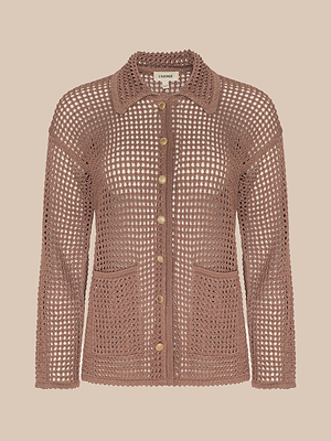 The Mariana Pointelle Knit Shirt is a brown crocheted cardigan with long sleeves, front pockets, gold buttons, and a collar, shown against a beige background.