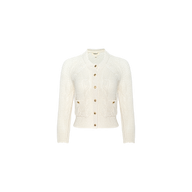 The Darcy Cable Knit Cardigan is a cream-colored, long-sleeve cardigan featuring a classic cable-knit design, patch pockets, and a round neckline. Crafted from a cotton-blend knit and finished with wooden buttons down the front, it is displayed on a plain white background.