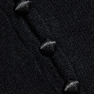 Close-up of the Eluna Cardigan Top’s textured black wool-blend fabric, featuring three glossy black buttons sewn in a diagonal line.