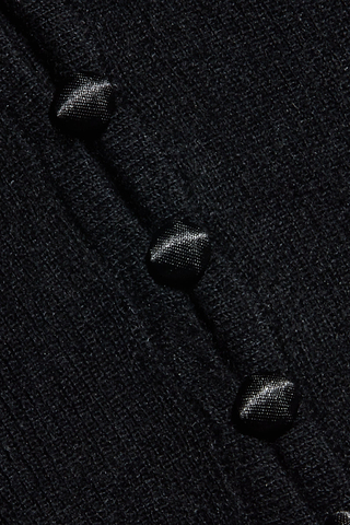 Close-up of the Eluna Cardigan Top, crafted from featherweight black wool-blend fabric and detailed with three glossy black hexagonal buttons arranged in a vertical row. The textured material adds depth to the design, while the buttons offer a subtle sheen.