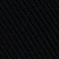 Close-up of the Conan Knit Pant’s textured black knit fabric, featuring diagonal ribbed lines that run across the surface. The lighting accentuates the raised ridges, adding depth and dimension to the material.