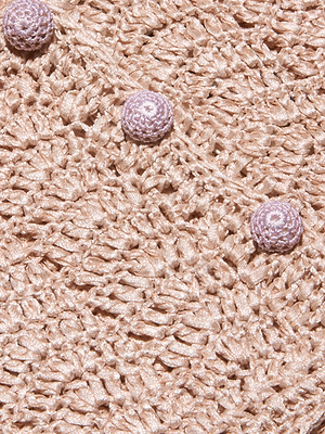 Close-up of the Fey Crocheted Tops textured, light pink fabric, showcasing three round, crocheted buttons arranged diagonally and an open, lace-like pattern.