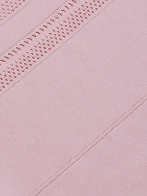 Close-up of the Taren Knit Dress in soft pink power knit fabric with diagonal seams and open-knit lace trim on top. Its smooth, delicately textured finish offers a gentle compression effect—perfect for a sleeveless style.