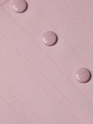 Close-up of the Dove Knit Corset Top, a light pink fitted piece featuring a ribbed power knit texture and four round buttons embossed with “LAGENCE” arranged in a neat vertical line. The design is finished with a subtle curved hemline.