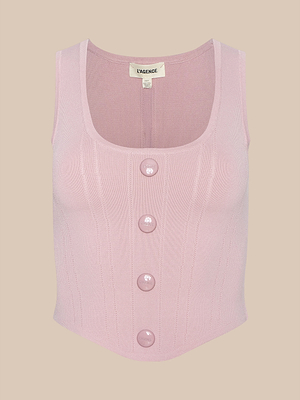 The Dove Knit Corset Top is a sleeveless, light pink power knit top with a scoop neckline, four matching front buttons, and subtle vertical ribbing. This fitted top is shown against a plain beige background.