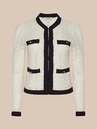 Zephyra Pointelle Knit Cardigan in white with black trim, featuring a textured pointelle knit design and four front pockets with gold buttons, shown against a neutral beige background for a cozy, chic look.