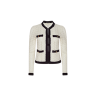The Zephyra Pointelle Knit Cardigan is a white textured women’s jacket with black trim, featuring four front pockets finished with decorative gold buttons. It has a round neckline and an open front, presented on a plain white background, echoing the timeless style of the classic Zephyra cardigan.