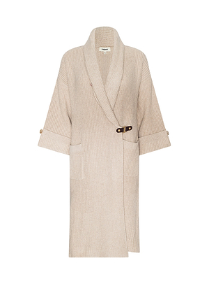 The Orielle Cardigan is a beige, knee-length ribbed knit with wide cuffed sleeves, two front pockets, and a dark waist buckle—perfect for Fall 2026 and New York Fashion Week.