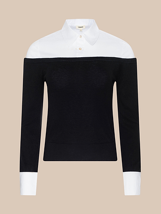 The Mathilde Poplin Collar Pullover is a long-sleeve black cropped pullover featuring a white poplin shirt-style collar, cuffs, and upper section for a layered look, set against a beige background.