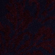 Close-up of the Naiad Jacquard Fringe Cardigan, featuring dark purple and black jacquard knit fabric with a subtle leafy or floral pattern, for a rich and soft look.