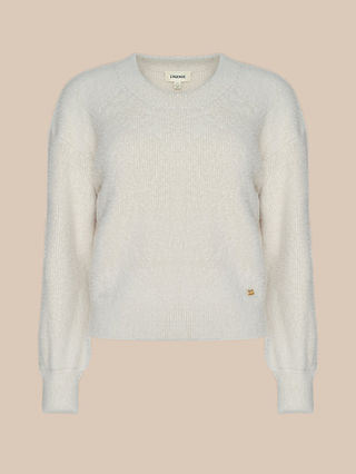 The Nimbus Pullover, a cream-colored knit sweater with long sleeves and ribbed cuffs and hem, is displayed against a beige background.