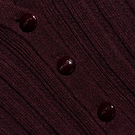 Close-up of a maroon, lightweight ribbed knit Finian Cardigan Top, cropped with three matching round buttons down the front.