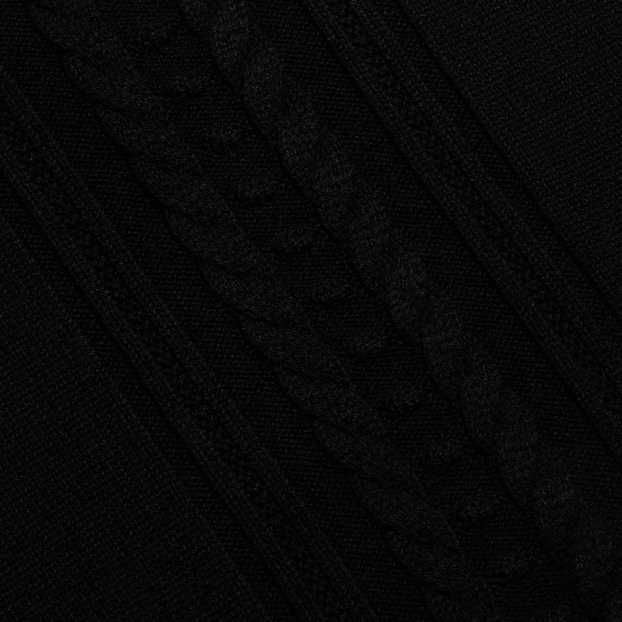 Sandrina Turtleneck in a black cable knit with a diagonal pattern and a relaxed fit.