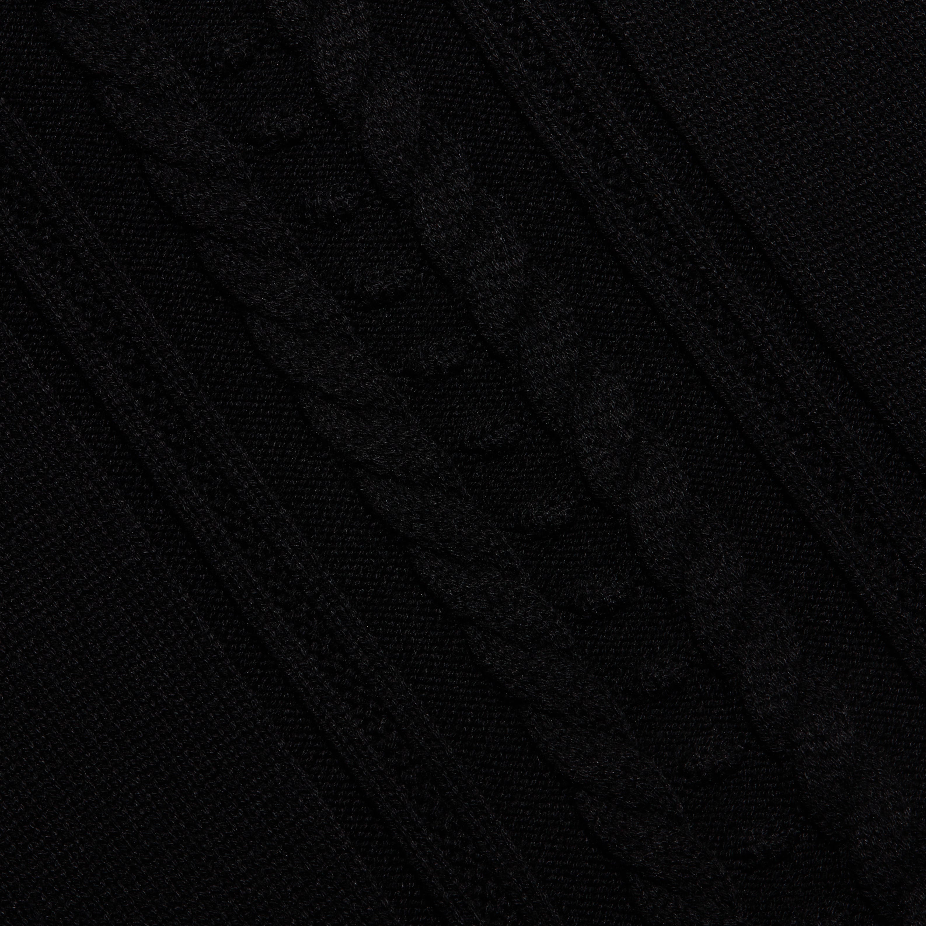 Sandrina Turtleneck in a black cable knit with a diagonal pattern and a relaxed fit.
