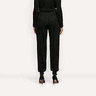 Back view of Tamaris Cable Knit Pant, featuring a soft slim-fit design with ribbed cuffs, worn with black high-heeled shoes.