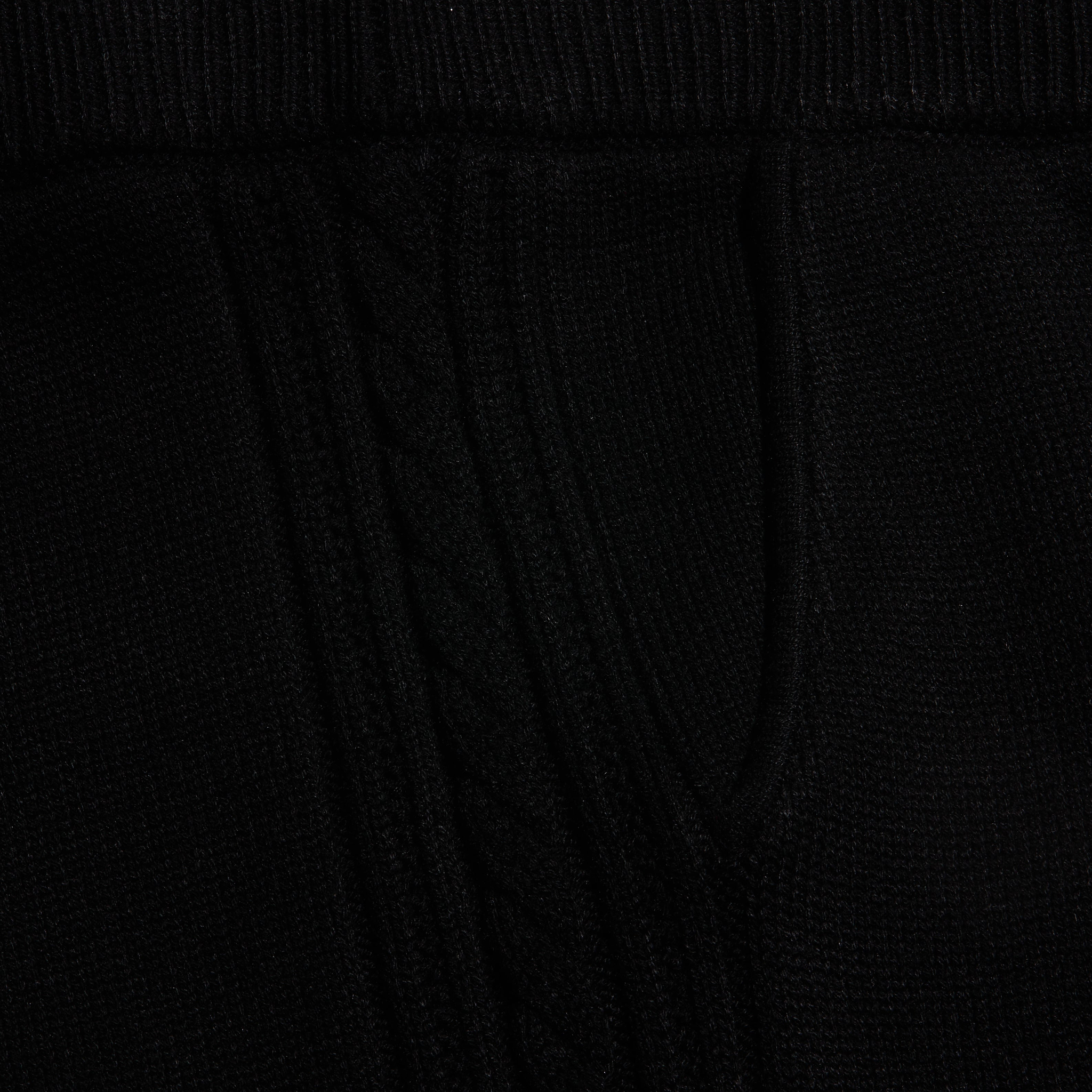 Close-up of the black Tamaris Cable Knit Pant, featuring soft fabric with a vertical cable knit pattern.