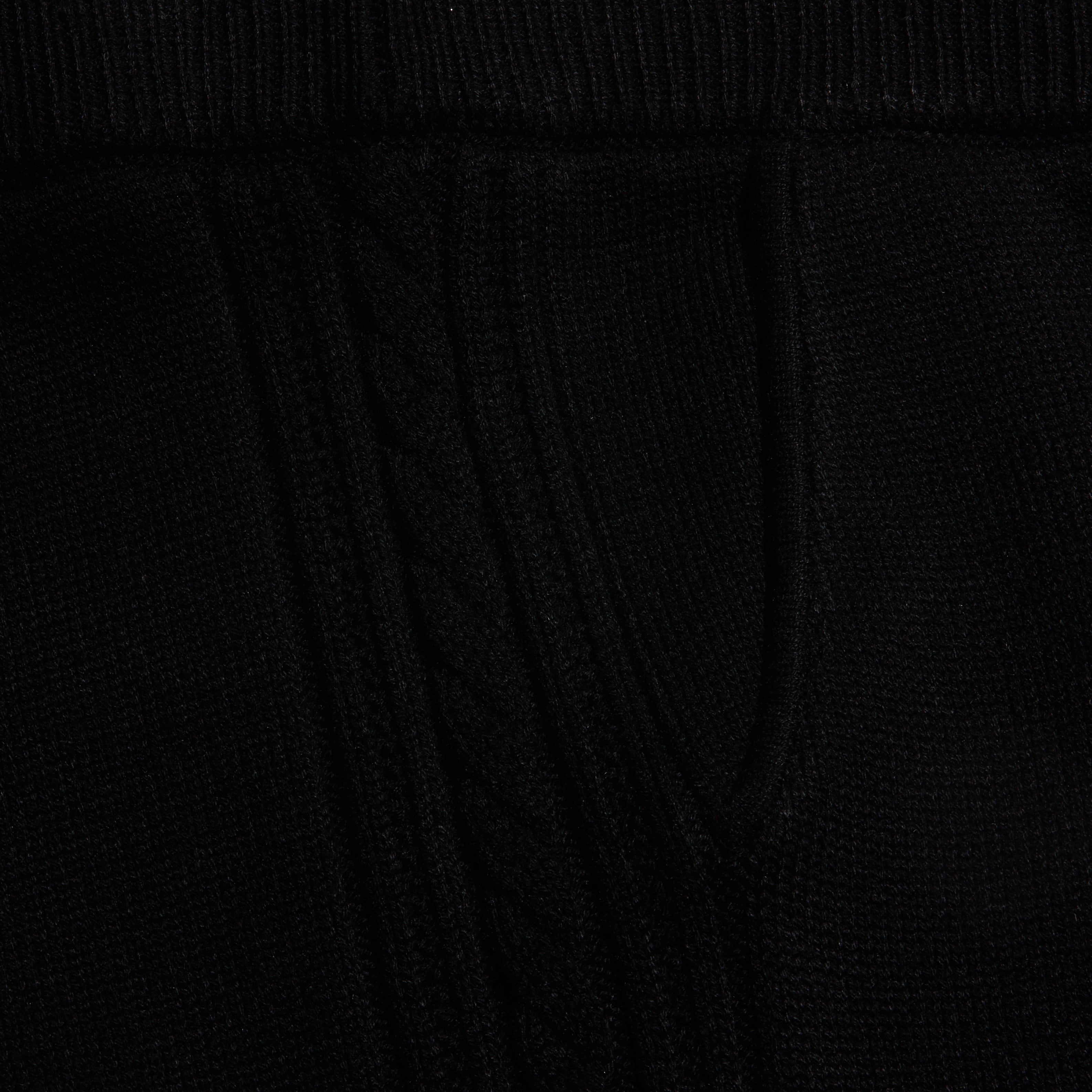 Close-up of the black Tamaris Cable Knit Pant, featuring soft fabric with a vertical cable knit pattern.