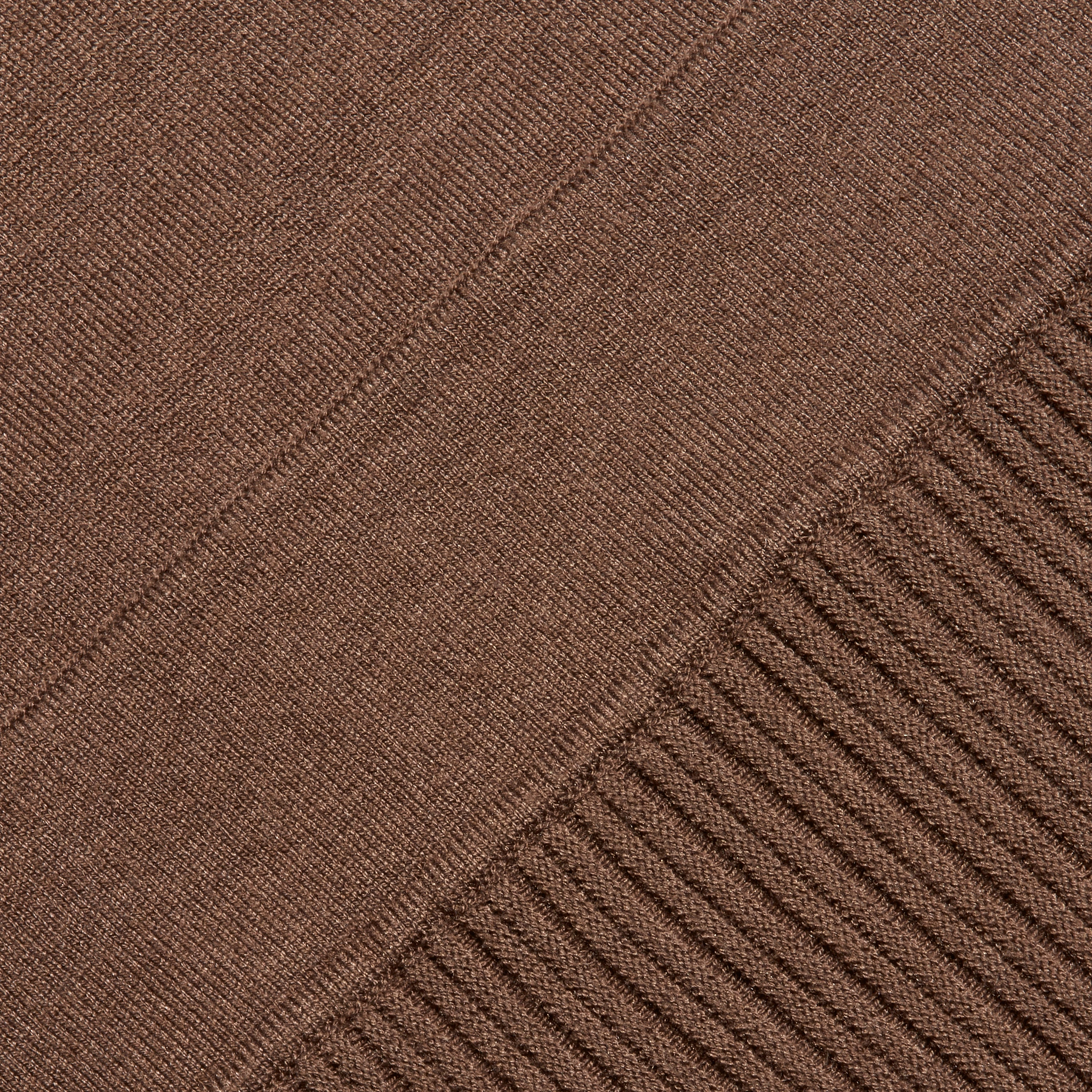 The Solaire Knit Dress is a brown fitted midi dress featuring a smooth knit section that transitions into a vertical ribbed pattern.