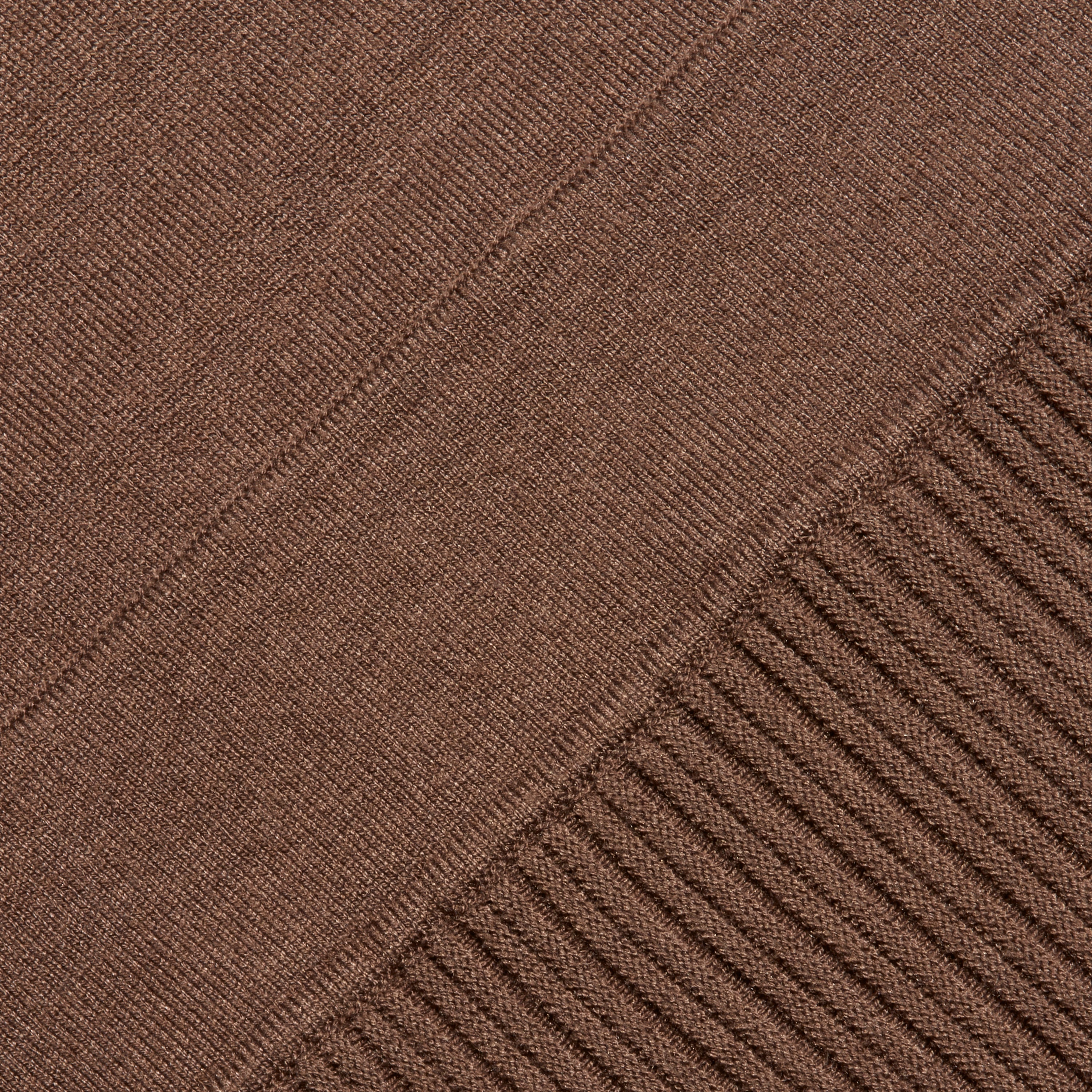 The Solaire Knit Dress is a brown fitted midi dress featuring a smooth knit section that transitions into a vertical ribbed pattern.