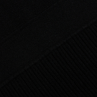 Close-up of the black Solaire Knit Dress, showing the transition from smooth knit fabric to a ribbed pattern.