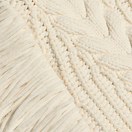 Close-up of an Ottavia Pullover, a chunky, off-white cable knit sweater featuring a combination of ribbed trim and a braided pattern.