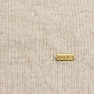 Close-up of a fuzzy, ribbed beige Korinna Pullover featuring a small rectangular gold-tone metal tag engraved with LAGENCE.