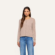 A woman wearing the Malone Cashmere Cardigan and blue jeans stands facing forward against a plain light background.