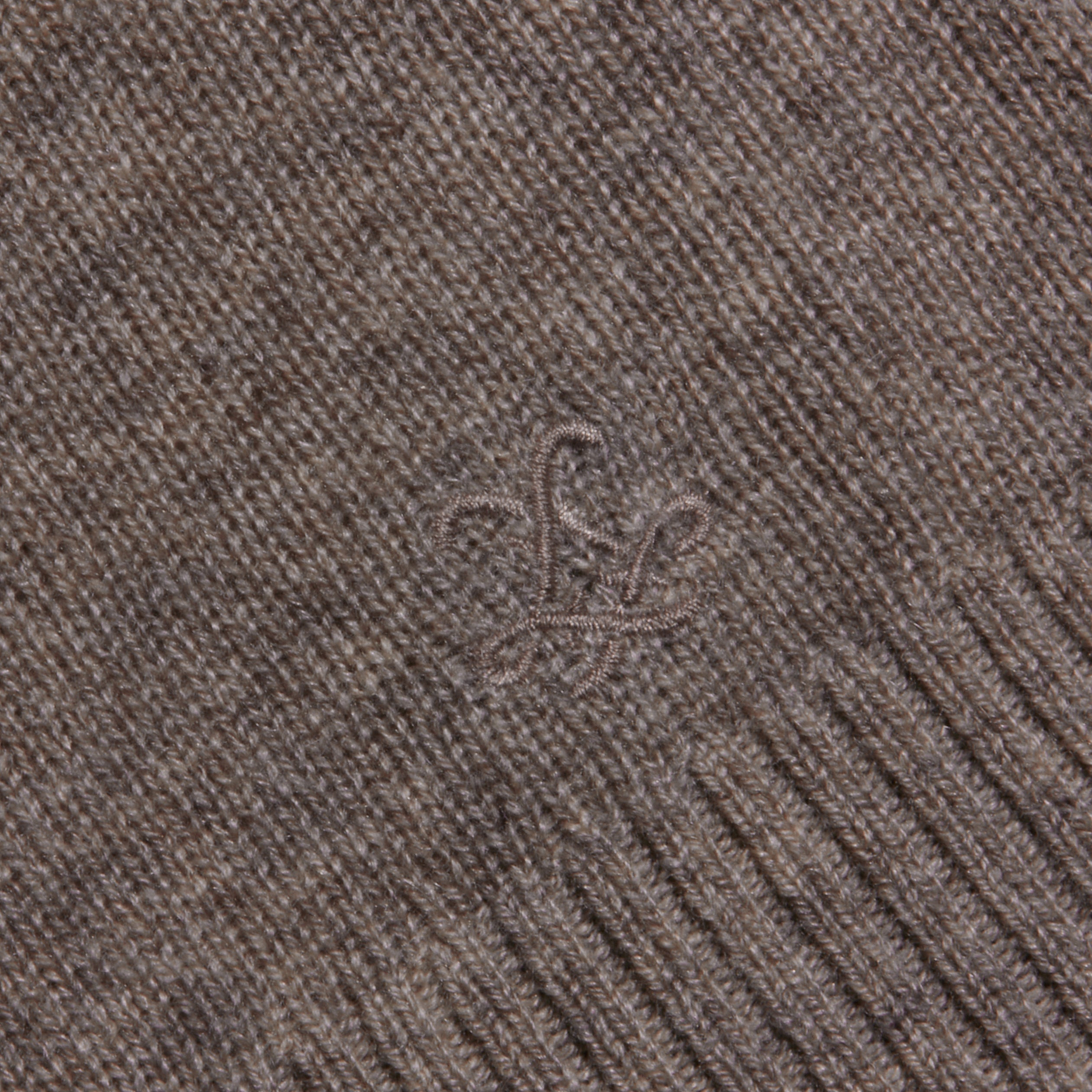 Close-up of the Malone Cashmere Cardigan, showcasing its brown knitted cashmere fabric with a subtle embroidered design and ribbed edging.