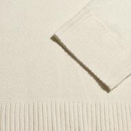 Selwyn Oversized Turtleneck in ivory with a ribbed cuff and hem.