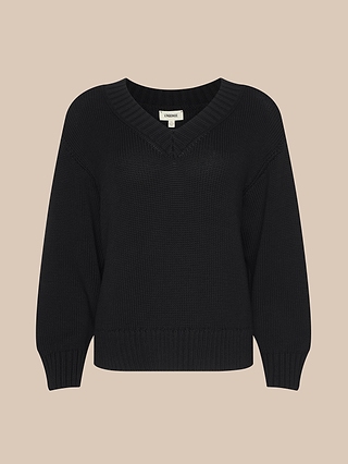 The Paxton Oversized Pullover is a black, long-sleeve knit cotton sweater featuring a V-neckline and ribbed cuffs and hem. This cozy v-neck pullover is displayed against a beige background.