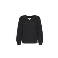 The Paxton Oversized Pullover is a black knitted cotton sweater with long sleeves and a V-neckline, displayed on a plain white background. This sweater features ribbed cuffs, hem, and collar, and offers a relaxed oversized fit.
