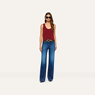A person wears a maroon Filou Cashmere Tank tucked into wide-leg blue jeans with a leopard-print belt and black sunglasses.