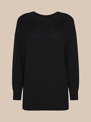 The Loden Pullover is a black knitted long-sleeve sweater featuring a round neckline and ribbed cuffs, hem, and collar. Designed with a relaxed fit for everyday comfort, it’s displayed against a plain beige background.