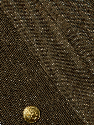 Close-up of the L'AGENCE Noe Double-Breasted Cardigan, featuring brown ribbed knit with a diagonal pattern, an ornate gold button, and a visible seam or pocket in the upper section.