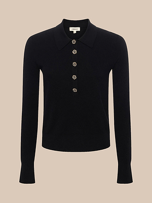 The Sterling Sweater is a black long sleeve knit polo with a collar and five floral buttons down the front, shown against a beige background.