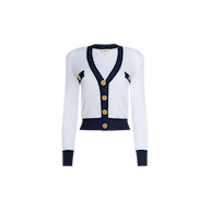 The Taya Cardigan is a Parisian-inspired white long-sleeve cardigan with navy blue trim, accented by gold buttons and elegant metallic detailing throughout. Decorative gold and navy accents adorn the sides, all showcased against a plain white background.