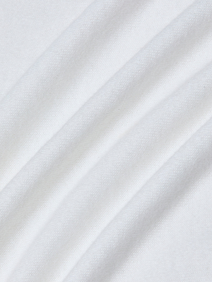 Close-up of the April Poplin Collar Pullover’s soft white featherweight knit, featuring gentle folds and a smooth, subtly textured surface that creates delicate shadows and highlights.